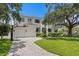 Beautiful exterior view of a two-story home showcasing a well-manicured front yard and a three-car garage at 534 Ladrone Ave, Tampa, FL 33606