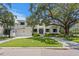 Stately two-story home exterior featuring a well-kept lawn, a prominent tree, and a spacious three-car garage at 534 Ladrone Ave, Tampa, FL 33606