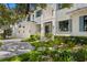 Stunning home featuring lush landscaping, a paver driveway, an attached two-car garage, and a charming front entrance at 534 Ladrone Ave, Tampa, FL 33606