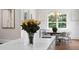 Bright kitchen with marble counters overlooking breakfast nook, hardwood floors, neutral decor, and stainless fixtures at 534 Ladrone Ave, Tampa, FL 33606