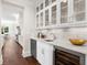 Wet bar with custom cabinetry, a wine fridge, and marble backsplash at 534 Ladrone Ave, Tampa, FL 33606
