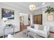Bright living room featuring stylish decor, hardwood floors, and a view into the adjacent library space at 534 Ladrone Ave, Tampa, FL 33606