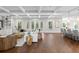 Open-concept living room featuring hardwood floors, coffered ceilings, and ample seating at 534 Ladrone Ave, Tampa, FL 33606