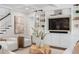 Comfortable living room featuring stylish built-in shelving, a modern fireplace, and staircase to upper floors at 534 Ladrone Ave, Tampa, FL 33606