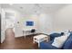 Comfortable living room with a blue couch, white table, and access to a workspace at 534 Ladrone Ave, Tampa, FL 33606