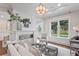 Cozy living room with a modern fireplace, elegant furniture, and a large window overlooking the landscaped yard at 534 Ladrone Ave, Tampa, FL 33606