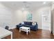 Cozy living room with a blue couch, white table, and access to a full bathroom at 534 Ladrone Ave, Tampa, FL 33606