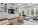 Bright living room features built-in shelving, coffered ceilings, and sliding doors to the outdoor area at 534 Ladrone Ave, Tampa, FL 33606