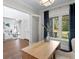 Home office with a wooden desk, large windows, and a view of the living area at 534 Ladrone Ave, Tampa, FL 33606