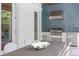 Outdoor kitchen features stainless steel appliances, blue subway tile backsplash, and a large dining table at 534 Ladrone Ave, Tampa, FL 33606