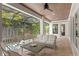 Screened patio offers an outdoor living area with comfortable seating and a view of the pool at 534 Ladrone Ave, Tampa, FL 33606