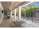 Outdoor patio with summer kitchen, dining area, and a screened-in pool view with a wood plank ceiling at 534 Ladrone Ave, Tampa, FL 33606