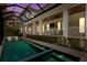 Inviting outdoor pool area with a screened enclosure, comfortable seating, and elegant architectural details at 534 Ladrone Ave, Tampa, FL 33606