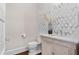 Stylish powder room with marble wallpaper and a decorated vanity at 534 Ladrone Ave, Tampa, FL 33606