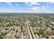 Expansive aerial view of a residential neighborhood with mature trees and a distant city skyline at 5611 Burlington N Ave, St Petersburg, FL 33710