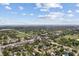Scenic aerial view of a neighborhood showcasing lush greenery, nearby park, and distant bay waters at 5611 Burlington N Ave, St Petersburg, FL 33710