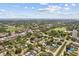 Picturesque aerial view of homes near green spaces, a golf course, and distant bay waters at 5611 Burlington N Ave, St Petersburg, FL 33710