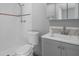 Bathroom with white tile shower, sleek toilet, and grey vanity with modern faucet at 5611 Burlington N Ave, St Petersburg, FL 33710