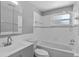Bathroom featuring a tub and shower combination, grey vanity, and mirrored cabinet at 5611 Burlington N Ave, St Petersburg, FL 33710