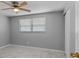 Bedroom with ceiling fan, neutral paint, and a big window at 5611 Burlington N Ave, St Petersburg, FL 33710