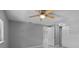 Spacious bedroom with a ceiling fan, neutral paint, and a view to a walk-in closet at 5611 Burlington N Ave, St Petersburg, FL 33710