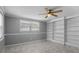 Bedroom featuring gray walls, white trim, built-in shelves, and a ceiling fan at 5611 Burlington N Ave, St Petersburg, FL 33710