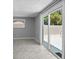 Bedroom featuring a sliding glass door to the backyard and a window with blinds at 5611 Burlington N Ave, St Petersburg, FL 33710