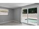 Bedroom view with sliding glass doors to the pool area and window with blinds at 5611 Burlington N Ave, St Petersburg, FL 33710