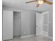 Inviting bedroom featuring a ceiling fan, ample closet space and neutral paint scheme at 5611 Burlington N Ave, St Petersburg, FL 33710