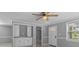 Cozy living room with gray walls, white trim, built-in cabinets, and a ceiling fan at 5611 Burlington N Ave, St Petersburg, FL 33710