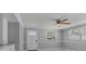 Well-lit living room featuring modern ceiling fan, beautiful windows, and neutral paint tones at 5611 Burlington N Ave, St Petersburg, FL 33710