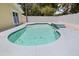 Backyard pool with waterfall feature surrounded by a white fence at 5611 Burlington N Ave, St Petersburg, FL 33710