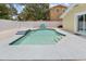 Backyard view of a swimming pool with steps and fountain features plus backyard lounge chairs at 5611 Burlington N Ave, St Petersburg, FL 33710