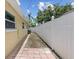 Side yard with brick paver path and white fence at 5611 Burlington N Ave, St Petersburg, FL 33710