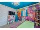 Stylish bedroom featuring a vibrant floral accent wall and unique blue ceiling at 6411 S Clark Ave, Tampa, FL 33616