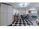 Spacious dining area with checkered floors, ample storage and a crystal chandelier at 6411 S Clark Ave, Tampa, FL 33616
