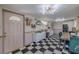 Open dining area showcasing checkered floors, stylish furnishings, and a decorative front door at 6411 S Clark Ave, Tampa, FL 33616