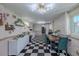 Bright dining area features a black-and-white checkered floor, and modern lighting fixture, and room for a long table at 6411 S Clark Ave, Tampa, FL 33616