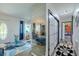 Bright entryway features a modern rug, decorative mirror, and convenient access to other areas of the home at 6411 S Clark Ave, Tampa, FL 33616