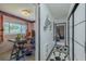 Hallway showcasing a bright office with natural light and a view into a stylish bedroom at 6411 S Clark Ave, Tampa, FL 33616