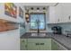 Charming kitchen featuring a stainless sink, updated cabinets, and appealing decor at 6411 S Clark Ave, Tampa, FL 33616