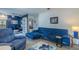 Comfortable living room showcasing a stylish blue sofa, ideal for relaxing and entertaining guests at 6411 S Clark Ave, Tampa, FL 33616