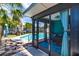 The backyard features a sparkling pool surrounded by stone pavers and a covered patio area at 6411 S Clark Ave, Tampa, FL 33616