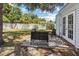 A cozy outdoor patio with modern black furniture set on a patterned rug in the fenced backyard at 6453 5Th N Ave, St Petersburg, FL 33710