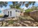 Fenced backyard featuring a detached bonus room and patio area for outdoor relaxation at 6453 5Th N Ave, St Petersburg, FL 33710