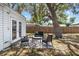 Cozy outdoor patio with modern black furniture set on a patterned rug in the fenced backyard at 6453 5Th N Ave, St Petersburg, FL 33710