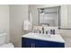 Bathroom featuring a navy blue vanity, a modern sink, and an updated mirror at 6453 5Th N Ave, St Petersburg, FL 33710