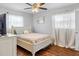 Bedroom featuring hardwood floors, natural light, and a vintage-style white wood bed frame at 6453 5Th N Ave, St Petersburg, FL 33710