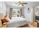 Cozy bedroom featuring natural light, a ceiling fan, and an ensuite bathroom at 6453 5Th N Ave, St Petersburg, FL 33710