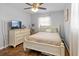 Bedroom featuring hardwood floors, natural light, and a vintage-style white wood bed frame at 6453 5Th N Ave, St Petersburg, FL 33710